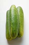 Three fresh cucumbers with drops of water