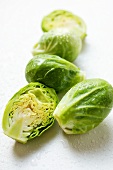 Brussels sprouts with drops of water, one halved