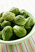 Fresh Brussels sprouts in white bowl