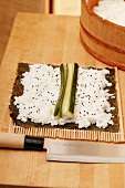 Preparing maki-sushi with cucumber