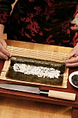 Preparing rolled sushi