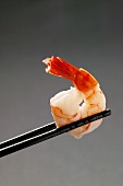 Peeled shrimp on chopsticks