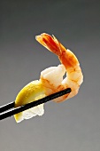 Shrimp with lemon wedge on chopsticks