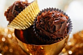 Chocolate truffles in golden bowl