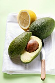 Avocados, whole and halved, with lemon