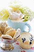 Almond macaroons & blueberry muffin in front of bouquet