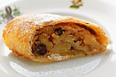 A piece of apple strudel with icing sugar