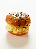 A doughnut with vanilla cream filling and glacé icing