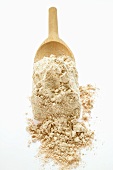 Wholemeal flour on wooden scoop
