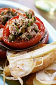 Tomatoes stuffed with tuna and capers; garlic bread