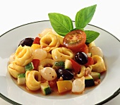 Tortellini with tomatoes, olives and courgettes