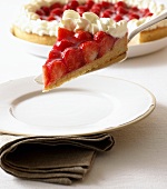 Piece of strawberry tart with cream on cake slice