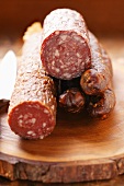 Various venison sausages on wooden plate