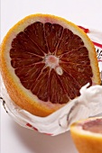 Half a blood orange on wrapping paper