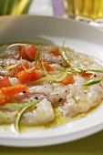 Carpaccio of raw shrimps, tomatoes and spring onions