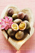 Passion fruits (Purple granadilla) in wooden bowl