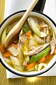 Chicken soup with vegetables in saucepan