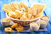 Various types of pasta in basket and bowls