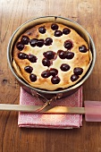 Freshly-baked cherry cake in baking tin