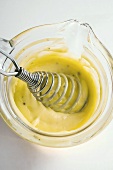 Hollandaise sauce in a small glass pan