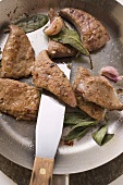 Fried calf's liver with sage and garlic in frying pan