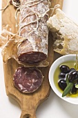 Italian salami, olives in olive oil, white bread