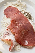 Coating veal escalope in flour