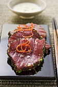 Raw tuna fillets with poppy seeds