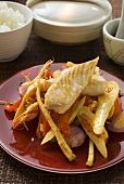 Fish fillets on bamboo shoots with peppers & enoki mushrooms