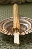 Chopsticks in woven case on plate
