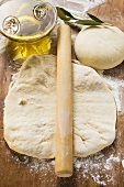 Rolled out & ball of dough, rolling pin, olive oil & branch
