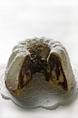 Marbled gugelhupf with icing sugar, pieces taken