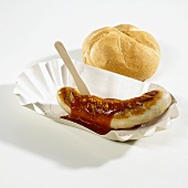 Currywurst (curry sausage) with bread roll