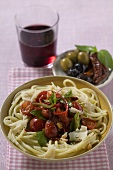 Spaghetti with tomatoes, glass of red wine