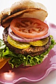 Home-made hamburger with gherkins, onions, tomato