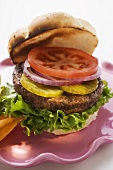 Home-made hamburger with gherkins, onions, tomato