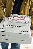 Several pizzas being delivered