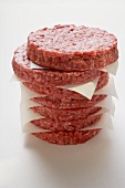 Raw burgers for hamburgers, in a pile