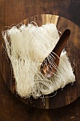 Thin rice noodles on wooden plate with spoon