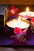 Thai table decoration: candles and orchids