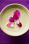 Purple orchid petals in bowl of water