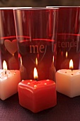 Three candles and red glasses for Valentine's Day