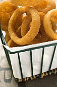 Deep-fried onion rings in a wire basket