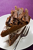 Two pieces of chocolate cake with chocolate curls