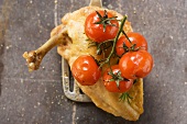 Fried chicken breast with cherry tomatoes on spatula