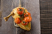 Fried chicken breast with cherry tomatoes on spatula