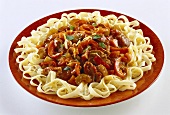 Meat and vegetable ragout on ribbon pasta