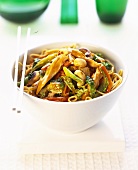 Asian pan-cooked chicken and vegetables with peanuts in bowl