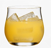 Orange juice with ice cubes in glass