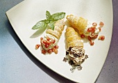 Three Cream Filled Puff Pastries with fruit and Chocolate
